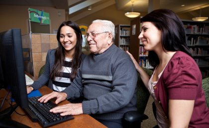 An older man with two family members undergoes a counselling session.